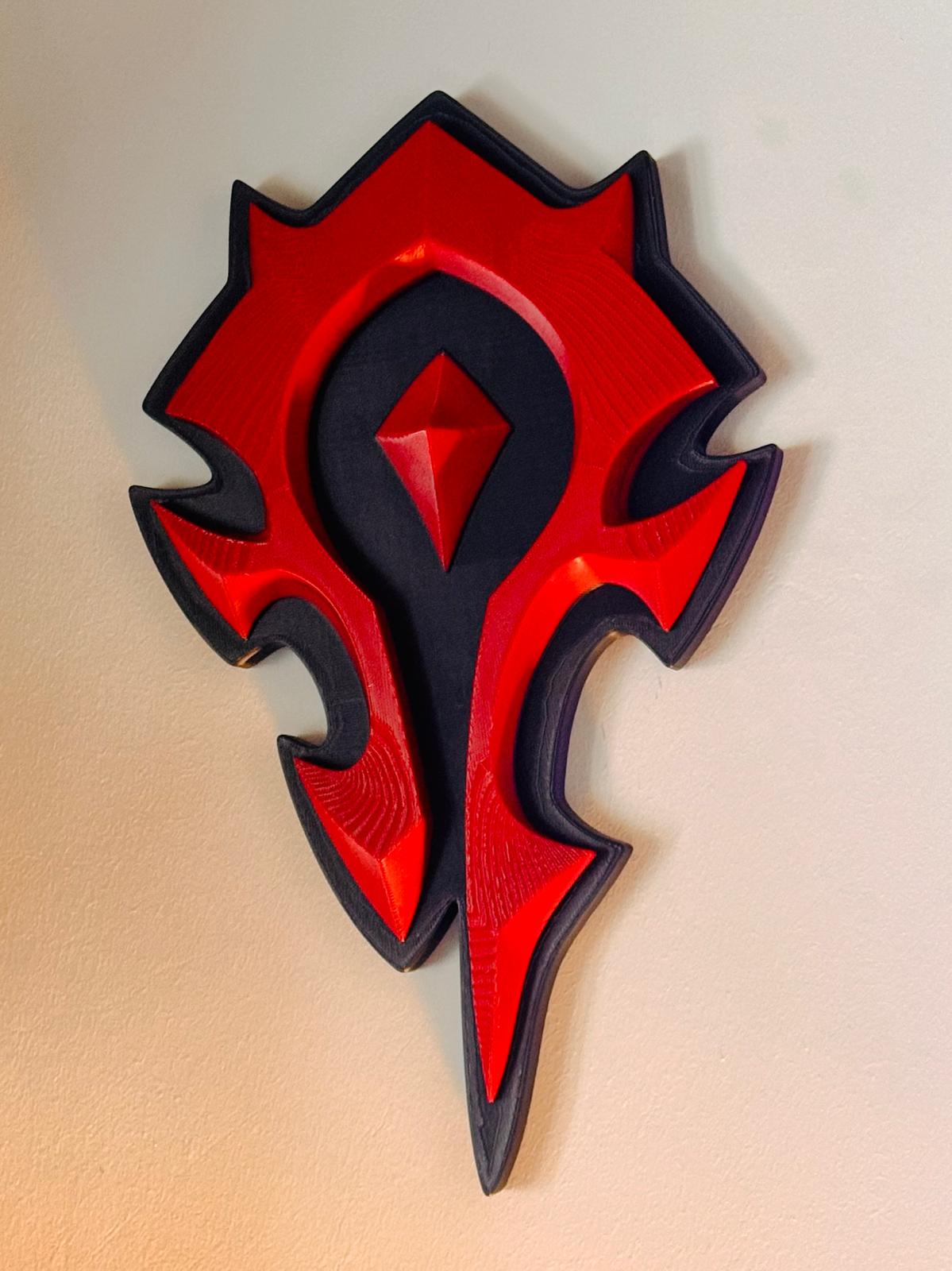 Front view of the red Horde Crest relief on its black base